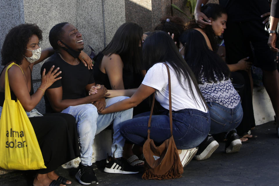 Family and friends grieve during the funeral of Kathlen Romeu, a young pregnant woman killed by a stray bullet, in Rio de Janeiro, Brazil, Wednesday, June 9, 2021. Stray bullets have struck at least six pregnant women in Rio since 2017, but Romeu was the first to die, according to Crossfire, a non-governmental data project that tracks armed violence. (AP Photo/Bruna Prado)
