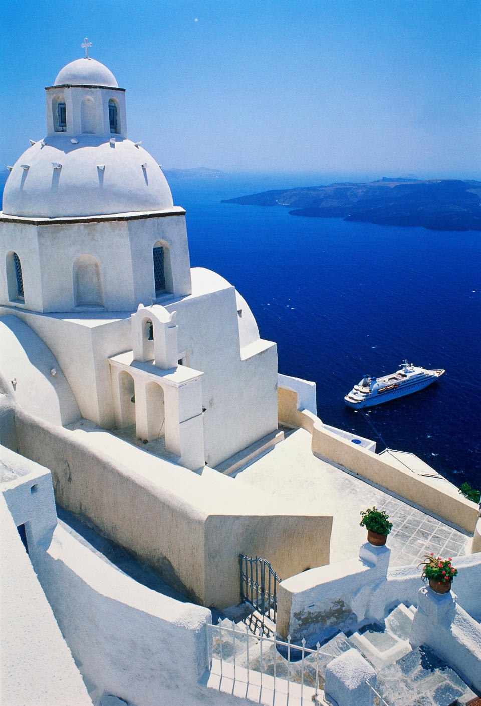 A view of whitewashed buildings and blue sea in Santorini.