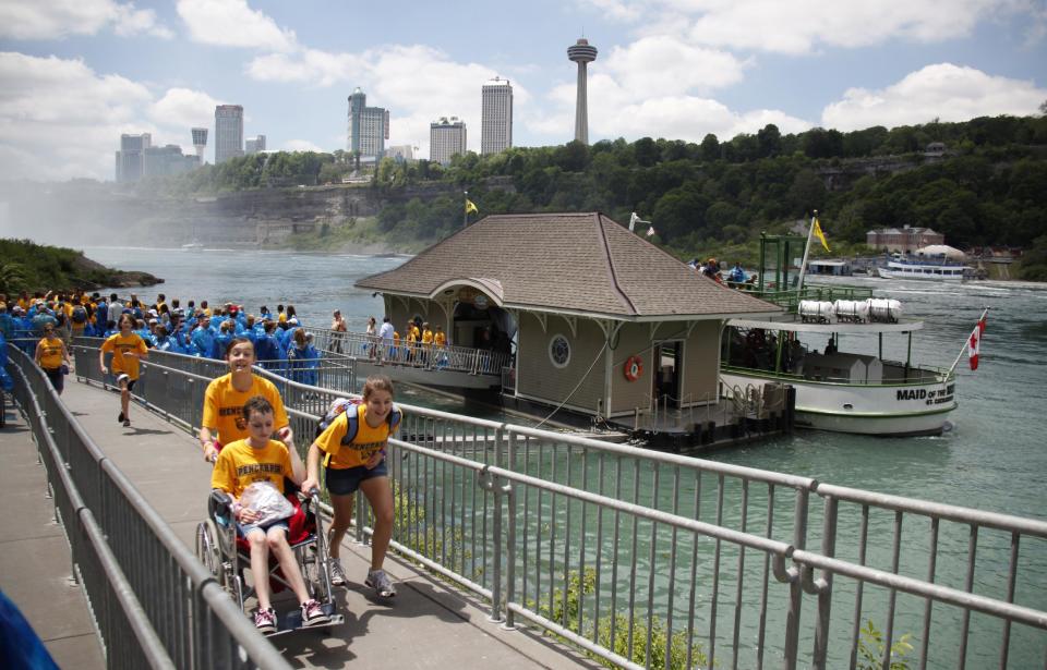 FILE - In this June 11, 2010 file photo, tourists exit the Maid of the Mist boat in Niagara Falls, N.Y. The tour company chosen to take over the Niagara Falls tour boat business in Canada says it plans to build customized new boats and upgrade amenities while maintaining the things that have made the sightseeing rides so popular for more than 100 years. (AP Photo/David Duprey, File)