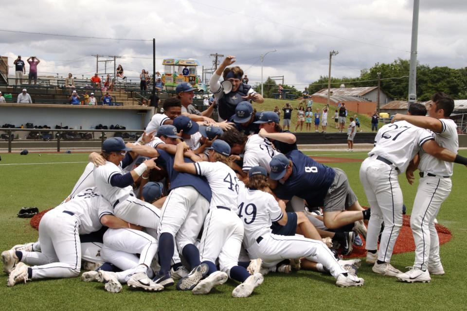 Heartland Community College players dogpile at David Allen Memorial Ballpark in Enid, Okla., after winning the NJCAA Div.-II World Series championship under head coach and IVC grad Chris Razo in early June.