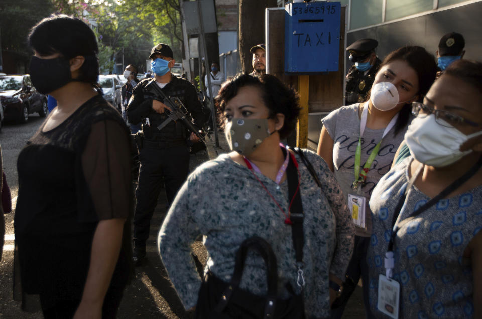 Nurses attend a demonstration outside a public hospital to protest their lack of protective gear, in Mexico City, Tuesday, April 21, 2020. The government has extended its social distancing measures through the end of May, predicting that the cases of the new coronavirus will peak in Mexico in about three weeks. (AP Photo/Fernando Llano)