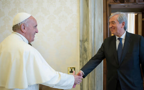 Pope Francis greets Libero Milone, the Vatican's then auditor general, during a meeting at the Vatican in 2016 - Credit: Reuters