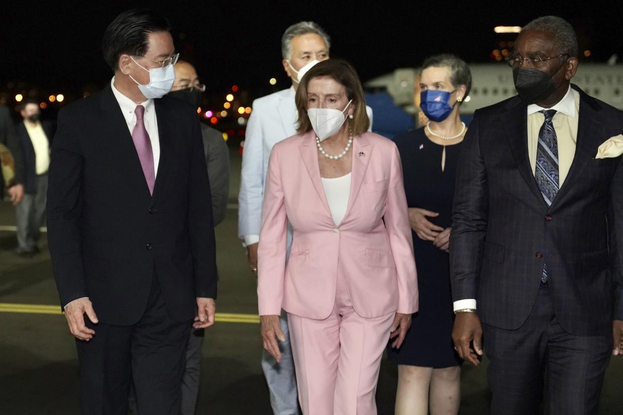 In this photo released by the Taiwan Ministry of Foreign Affairs, House Speaker Nancy Pelosi, center, walks with Taiwan's Foreign Minister Joseph Wu, left, as she arrives in Taipei, Taiwan, Tuesday, Aug. 2, 2022. 