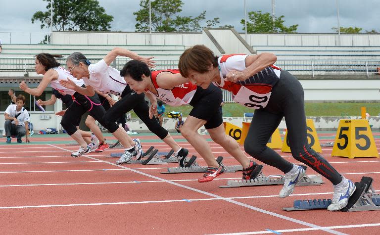 85-year-old Japanese athlete Mitsue Tsuji (R) starts during women's 60m dash at a Japan Masters Athletics competition in Kyoto on August 3, 2014