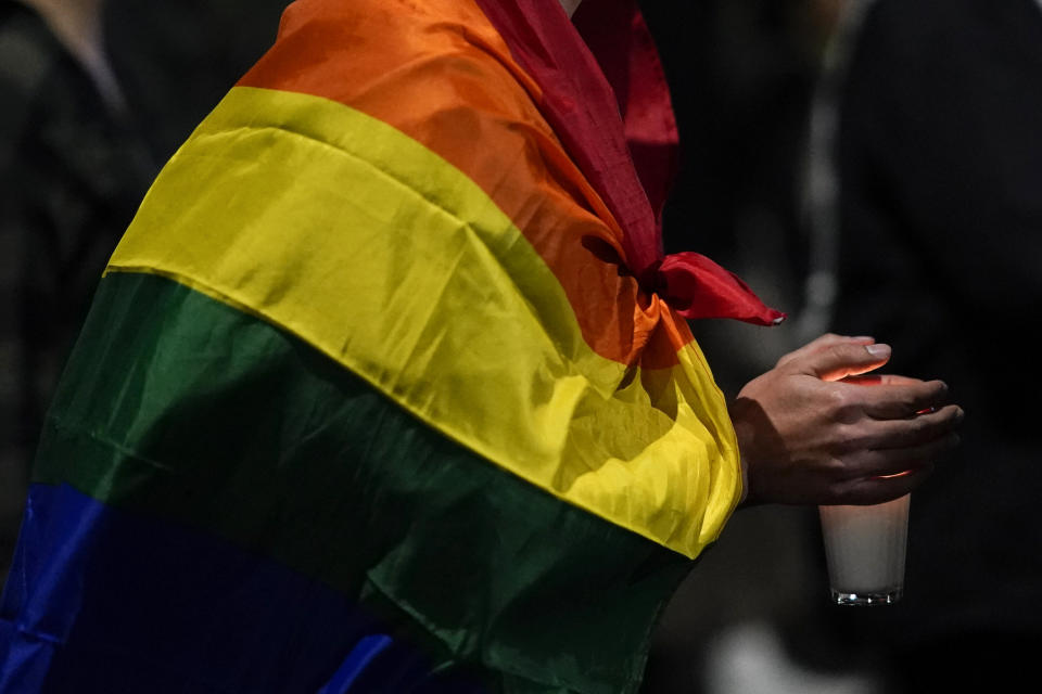 A demonstrator holds a candle during a protest in Mexico City, Monday, Nov. 13, 2023. The first openly nonbinary person to assume a judicial position in Mexico was found dead in their home Monday in the central Mexican city of Aguascalientes after receiving death threats because of their gender identity, authorities said. (AP Photo/Eduardo Verdugo)