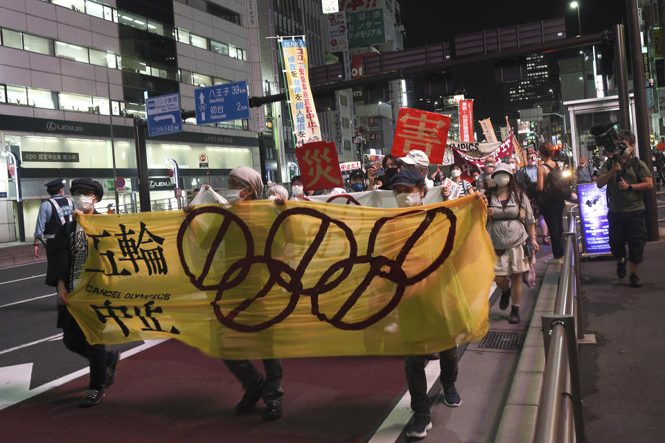 FILE - In this June 23, 2021, file photo, protesters call for the cancellation of the Tokyo Olympics slated to start in 30 days, near the Tokyo Metropolitan Government building in Tokyo. The Tokyo Olympics are going ahead despite opposition from many quarters inside Japan. The Japanese medical community is largely against it. (AP Photos/Kantaro Komiya, File)