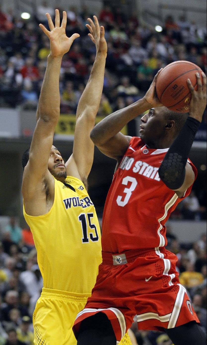 Ohio State guard Shannon Scott (3) goes up for a shot against Michigan forward Jon Horford (15) in the first half of an NCAA college basketball game in the semifinals of the Big Ten Conference tournament Saturday, March 15, 2014, in Indianapolis. (AP Photo/Kiichiro Sato)