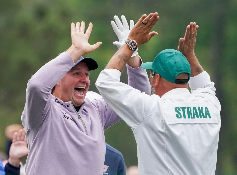 Sepp Straka (left) celebrates with his caddie John Davenport after making a hole-in-one on the 12th hole during a practice round for The Masters golf tournament on Monday at the Augusta National Golf Club.