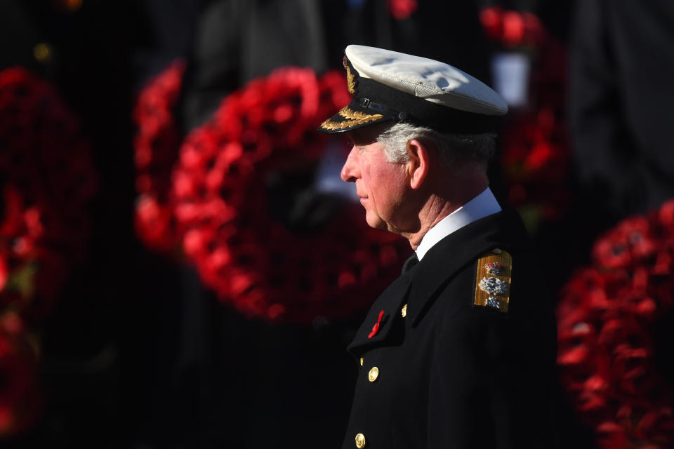 The Prince of Wales laid the first wreath on behalf of the Queen, who watched the service from a nearby balcony (Picture: SWNS)