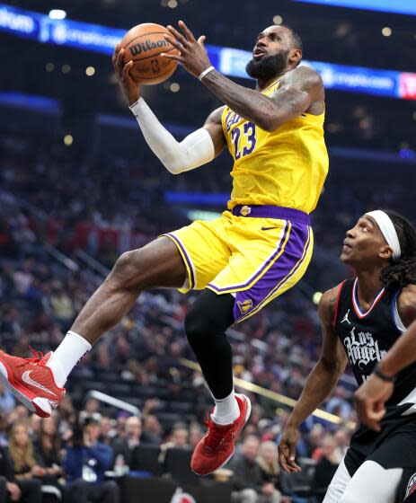 The Lakers' LeBron James drives past the Clippers' Terance Mann in the second quarter at Crypto.com Arena Wednesday.