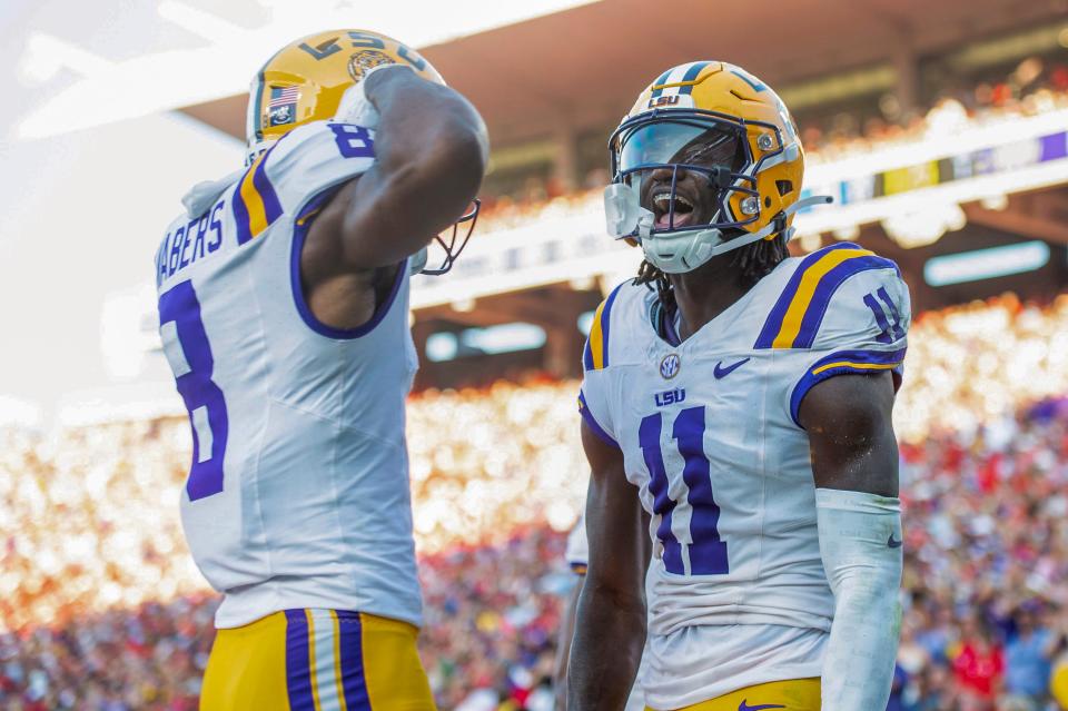 OXFORD, MISSISSIPPI - SEPTEMBER 30: Wide receiver Brian Thomas Jr. #11 of the LSU Tigers celebrates with wide receiver Malik Nabers #8 of the LSU Tigers after scoring a touchdown during the first half of their game against the LSU Tigers against the Mississippi Rebels at Vaught-Hemingway Stadium on September 30, 2023 in Oxford, Mississippi. (Photo by Michael Chang/Getty Images)