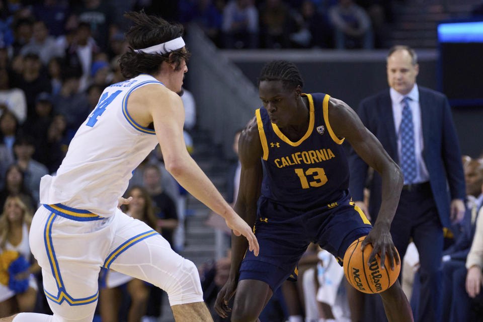 California forward Kuany Kuany (13) is defended by UCLA guard Jaime Jaquez Jr. during the first half of an NCAA college basketball game Saturday, Feb. 18, 2023, in Los Angeles. (AP Photo/Allison Dinner)