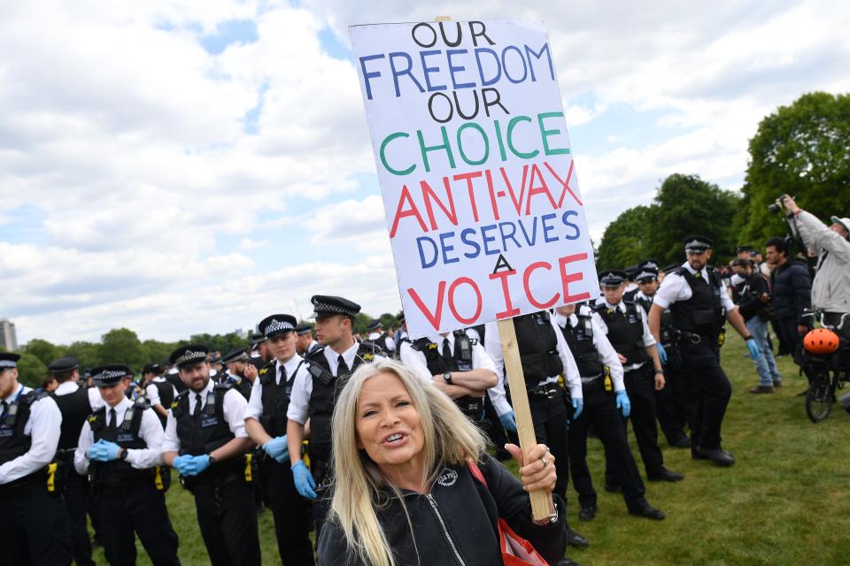 A protester carries a sign with an anti-vaccination slogan during an anti-coronavirus lockdown demonstration in Hyde Park in London on May 16. (Photo: JUSTIN TALLIS via Getty Images)