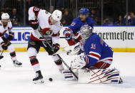 New York Rangers goalie Igor Shesterkin (31) stops Ottawa Senators left wing Tim Stutzle (18) as Rangers defenseman Adam Fox (23) assists Shesterkin during the first period of an NHL hockey game Friday, Dec. 2, 2022, in New York. (AP Photo/John Munson)