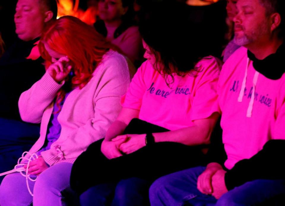 Athena Strand’s mother Maitlyn Presley Gandy wipes a tear away as she sits with other family members during a vigil for 7-year-old Athena Strand at the First Baptist Church of Cottondale on Tuesday. About 2,500 people attended her vigil.