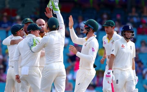 England's captain Joe Root reacts as Australia's Nathan Lyon celebrates with team mates dismissing Dawid Malan during the fourth day of the fifth Ashes cricket test match - Credit: &nbsp;REUTERS