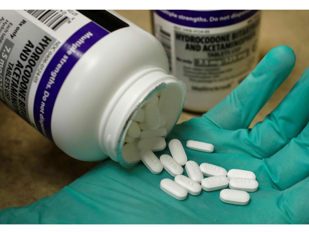 A pharmacist holds the prescription opioid hydrocodone: Reuters