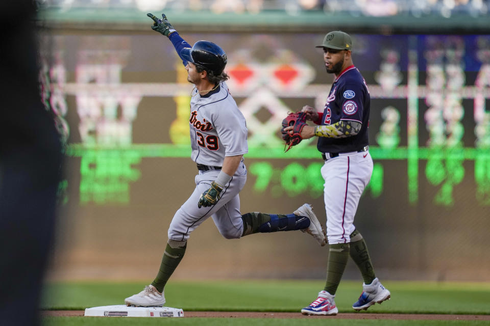 Detroit Tigers' Zach McKinstry celebrates as he runs the bases on a solo home run, with Washington Nationals second baseman Luis Garcia at right, during the first inning of a baseball game at Nationals Park, Friday, May 19, 2023, in Washington. (AP Photo/Alex Brandon)