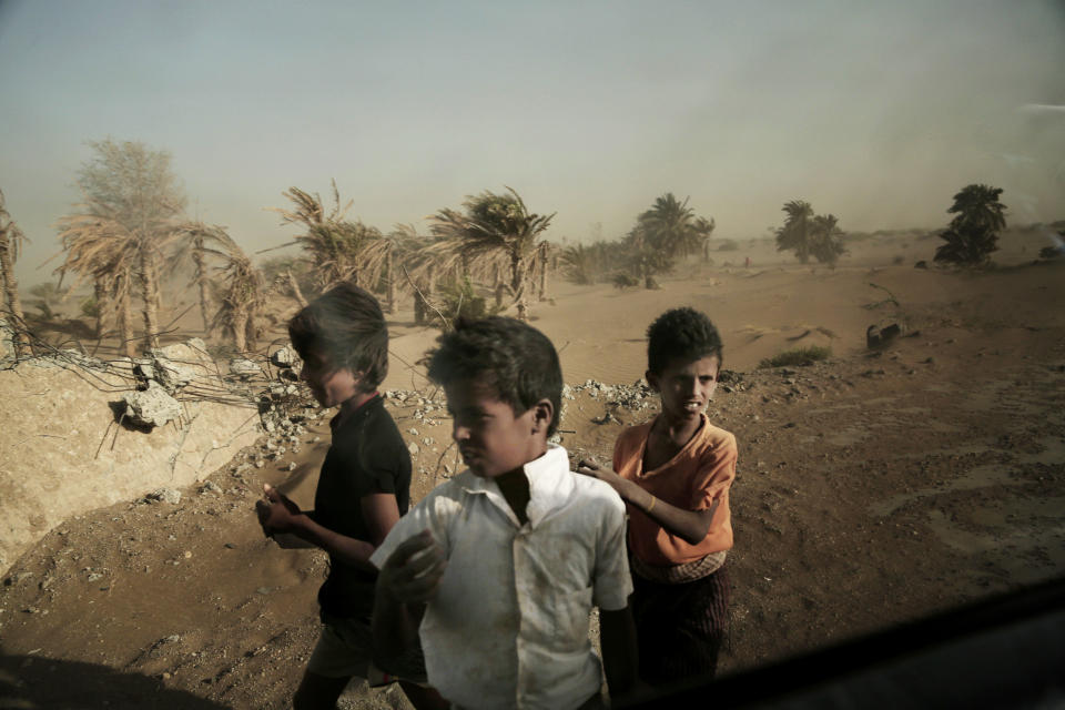FILE - In this Feb. 12, 2018 file photo, homeless children stand on the road in Hodeida, Yemen. With US backing, the United Arab Emirates and its Yemeni allies have restarted their all-out assault on Yemen’s port city of Hodeida, aiming to wrest it from rebel hands. Victory here could be a turning point in the 3-year-old civil war, but it could also push the country into outright famine. Already, the fighting has been a catastrophe for civilians on the Red Sea coast. (AP Photo/Nariman El-Mofty, File)