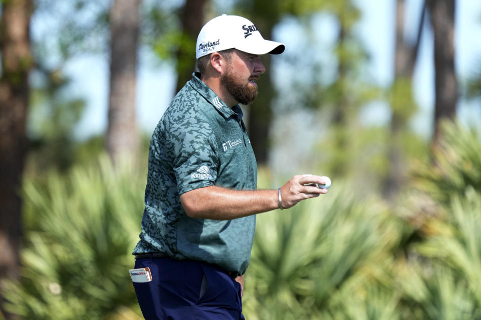 Shane Lowry, of Ireland, acknowledges the gallery after putting on the eighth green during the third round of the Honda Classic golf tournament, Saturday, Feb. 25, 2023, in Palm Beach Gardens, Fla. (AP Photo/Lynne Sladky)