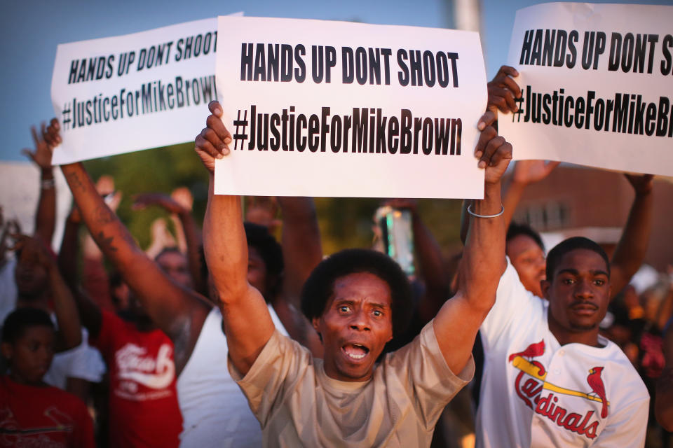 <p>Demonstrators protest the killing of teenager Michael Brown outside Greater St. Marks Family Church while Browns family along with civil rights leader Rev. Al Sharpton and a capacity crowd of guests met inside to discuss the killing on August 12, 2014 in St Louis, Missouri. Brown was shot and killed by a police officer on Saturday in the nearby suburb of Ferguson. Ferguson has experienced two days of violent protests since the killing but, tonight the town remained mostly peaceful. (Scott Olson/Getty Images) </p>