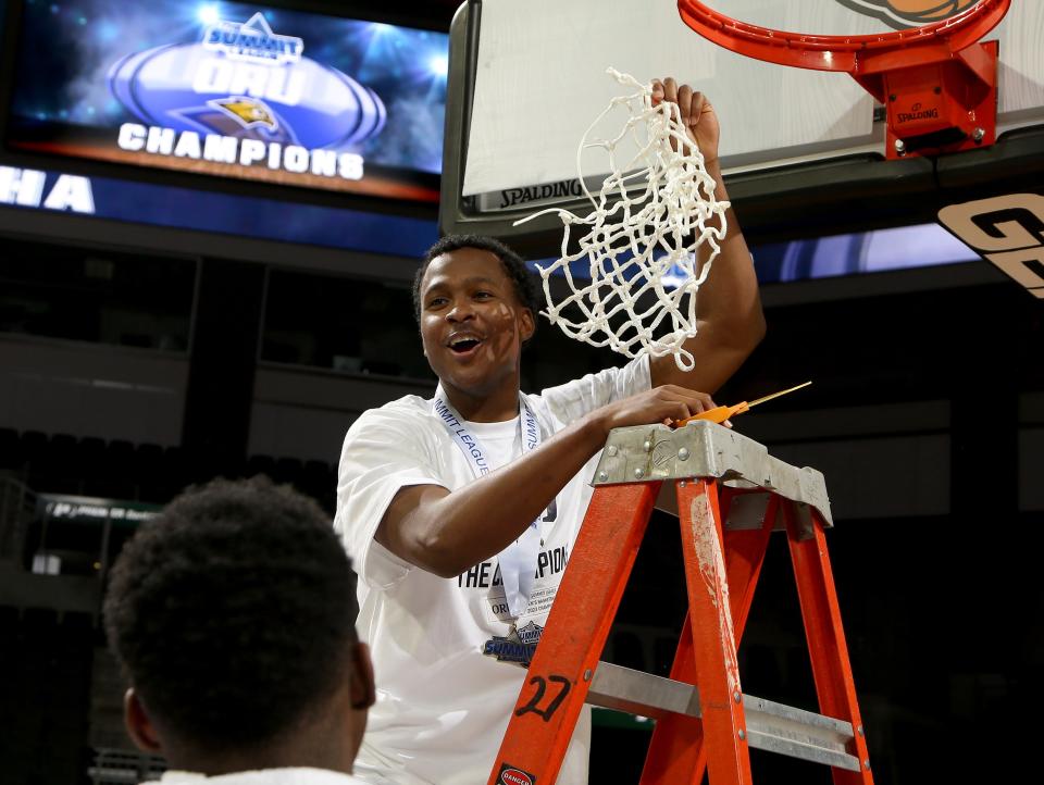 Oral Roberts Golden Eagles team cuts down net after winning championship game against the North Dakota State Bison, 92-50, at the 2023 Men’s Summit League Basketball Championship Game at the Denny Sanford Premier Center in Sioux Falls, South Dakota.