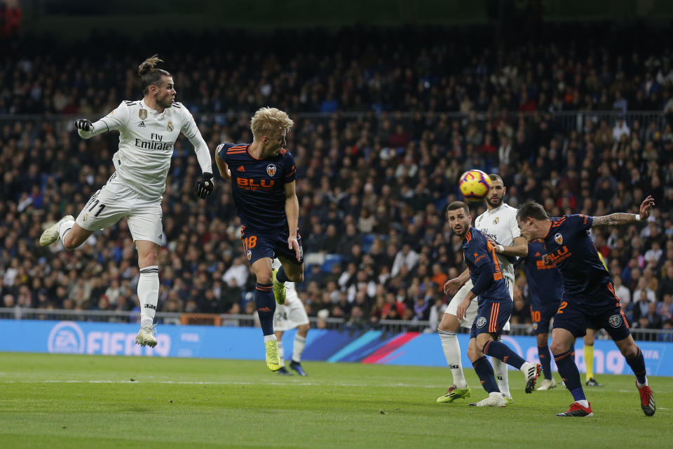 Real Madrid's Gareth Bale, left, heads the ball on goal during a Spanish La Liga soccer match between Real Madrid and Valencia at the Santiago Bernabeu stadium in Madrid, Spain, Saturday, Dec. 1, 2018. (AP Photo/Paul White)