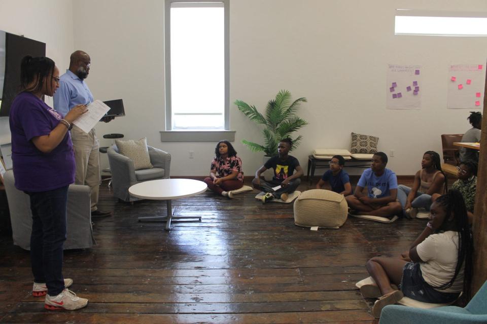 Shareen Baptiste, left, introduce David Canton, Ph. D., right, to students attending an event about gun violence awareness and prevention in Gainesville on Saturday. Canton spoke about the historical analysis of gun violence in the United States.
(Credit: Photo by Voleer Thomas/For The Guardian)