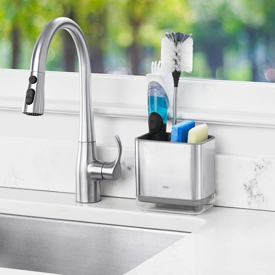 Keep your favorite scrubbing tools in one neat place instead of strewn all over the sink. This caddy even has a handy drip tray so you can empty out any moisture.<br /><br /><strong>Promising review:</strong> "I love all <a href="https://amzn.to/3aklxi1" target="_blank" rel="nofollow noopener noreferrer" data-skimlinks-tracking="5723569" data-vars-affiliate="Amazon" data-vars-href="https://www.amazon.com/stores/node/2598021011?_encoding=UTF8&amp;field-lbr_brands_browse-bin=OXO&amp;ref_=bl_dp_s_web_2598021011&amp;tag=bfjasmin-20&amp;ascsubtag=5723569%252C24%252C31%252Cmobile_web%252C1%252C0%252C14870725" data-vars-keywords="cleaning" data-vars-link-id="14870725" data-vars-price="" data-vars-product-id="16621214" data-vars-retailers="Amazon">OXO products</a> and am also happy with this purchase. I place my dish sponges in this and there is enough room for a brush as well. I like also the vent insert which keeps the sponges separate. The compartment at the bottom is a great idea in the design to allow for emptying water rather than letting it pool at the bottom. It is a separate compartment which is of clear plastic and allows you to visibly see if it needs emptying. Great product. Very satisfied." &mdash; <a href="https://amzn.to/3e9tK9J" target="_blank" rel="nofollow noopener noreferrer" data-skimlinks-tracking="5723569" data-vars-affiliate="Amazon" data-vars-href="https://www.amazon.com/gp/customer-reviews/R29SY51ECYVJGM?tag=bfjasmin-20&amp;ascsubtag=5723569%2C24%2C31%2Cmobile_web%2C0%2C0%2C0" data-vars-keywords="cleaning" data-vars-link-id="0" data-vars-price="" data-vars-retailers="Amazon">Amazon Customer</a><br /><br /><strong>Get it from Amazon for <a href="https://amzn.to/2RFMuWW" target="_blank" rel="noopener noreferrer">$13.99</a> (available in two colors).</strong>