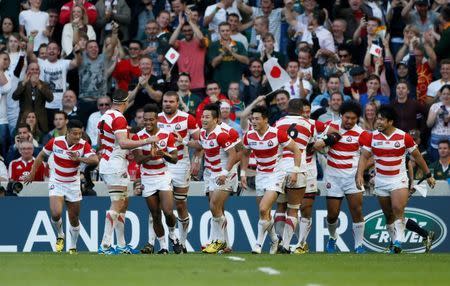 Japan's Ayumu Goromaru (3rd R) celebrates scoring their second try with teammates. Reuters / Stefan Wermuth