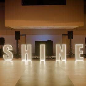 Illuminated letters spell out “SHINE” on the dance floor at the McNease Convention Center. IMage courtesy of Stacy McCormick.