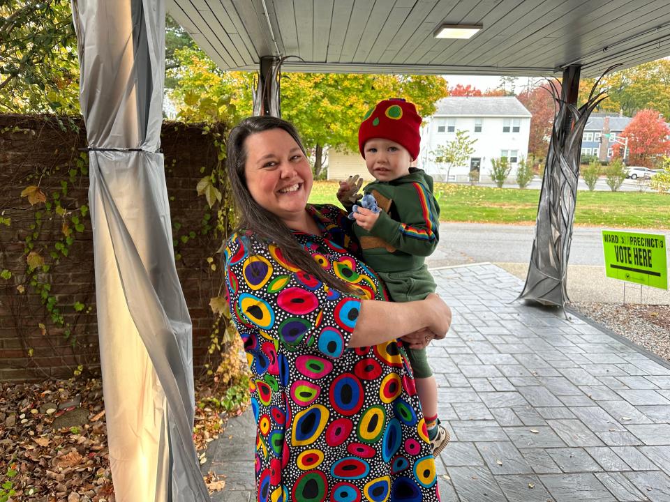 Meg Price and her son, Henry, leave the Worcester Center for Crafts after she cast her ballot Tuesday morning.