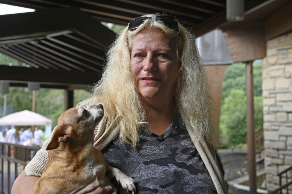 Ivallean Smith, who awoke to rising floodwaters when her pet chihuahua Coco, left, licked her hand, is being sheltered with other evacuees at Jenny Wiley State Park in Prestonsburg, Ky., Tuesday, Aug. 23, 2022. (AP Photo/Timothy D. Easley)