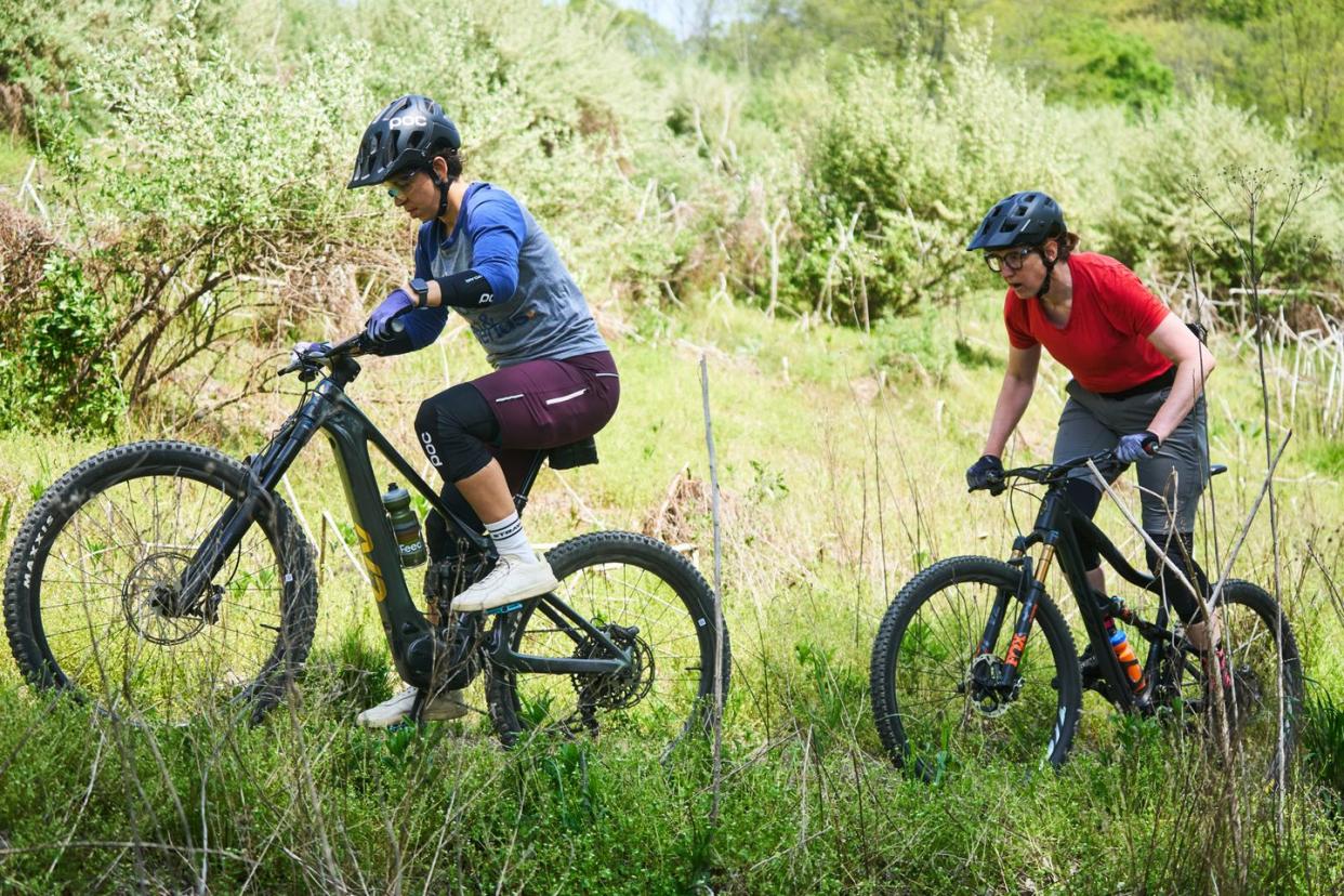 riding a mtn bike ebike on a trail with a friend