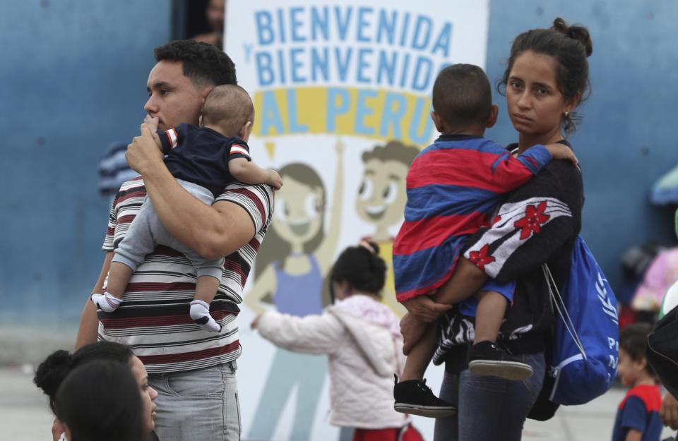 A couple of Venezuelan migrants arrive to migration controls in Tumbes, Peru, Friday, June 14, 2019. Venezuelan citizens are rushing to enter Peru before the implementation of new entry requirements on migrants fleeing the crisis-wracked South American nation. (AP Photo/Martin Mejia)