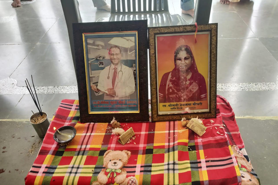 In this Sept. 17, 2020 photo provided by Kapil Chaudhary shows pictures of Joginder Chaudhary and his mother Premlata Chaudhary sitting on a table during a Hindu mourning ceremony held at the family home in Jhantala, Madhya Pradesh, India. fter the virus killed the 27-year-old Chaudhary in late July 2020, his mother wept inconsolably. With her son gone, Premlata Chaudhary said, how could she go on living? Three weeks later, on Aug. 18, the virus took her life, too — yet another number in an unrelenting march toward a woeful milestone. (Courtesy of Kapil Chaudhary via AP)