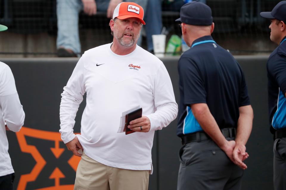 Oklahoma State coach Kenny Gajewski talks with an umpire during a game against North Texas in Stillwater on March 22.