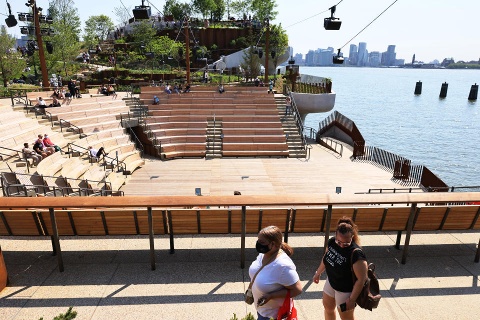 NEW YORK, NEW YORK - MAY 21: People enjoy the Little Island public park in Manhattan on May 21, 2021 in New York City. The Little Island public park on 13th Street in Hudson River Park opened for the first time to the public today. The features 350 different flowers, trees and shrubs. A 687-seat amphitheater with independent arts programming starting in June. The park also has space for seating for food and beverages from vendors.  (Photo by Michael M. Santiago/Getty Images)