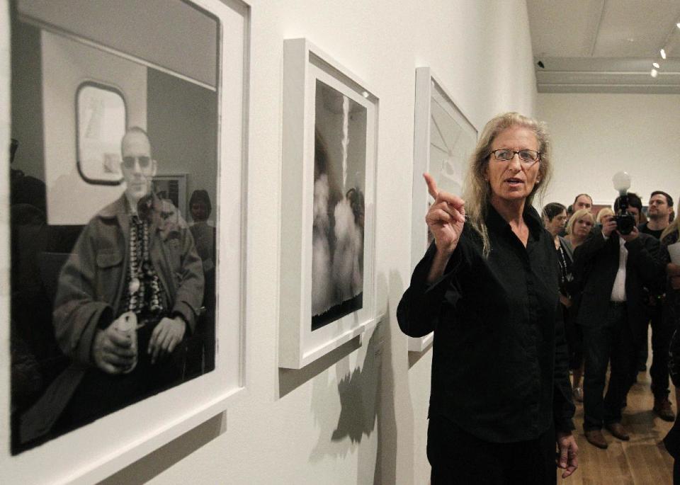 Annie Leibovitz talks about some of her work during a tour of her exhibition at the Wexner Center for the Arts Friday, Sept. 21, 2012, in Columbus, Ohio. Leibovitz's exhibition features work from her “Master Set,” an authoritative edition of 156 images. (AP Photo/Jay LaPrete)