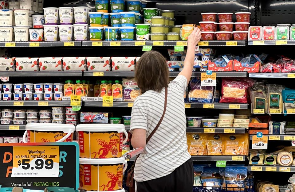 FILE - A customer looks at refrigerated items at a Grocery Outlet store in Pleasanton, Calif., Sept. 15, 2022. More U.S. adults are now feeling financially vulnerable amid high inflation. A new poll from The Associated Press-NORC Center for Public Affairs Research says that some 46% of people now call their personal financial situation poor. That figure has risen from 37% percent in March. (AP Photo/Terry Chea, File)