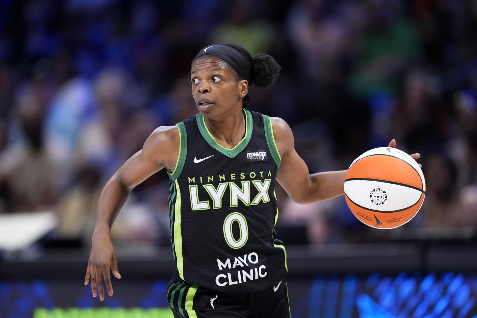 Minnesota Lynx's Olivia Epoupa handles the ball during a WNBA basketball game against the Dallas Wings in Arlington, Texas, Thursday, June 27, 2024. (AP Photo/Tony Gutierrez)