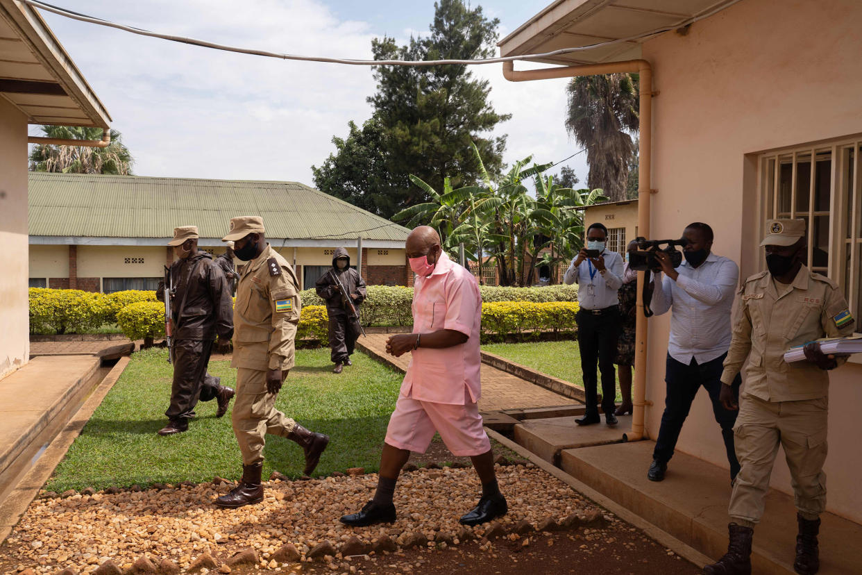 Paul Rusesabagina, center, surrounded by guards of Rwanda Correctional Service, arrives at Nyarugenge Court of Justice in Kigali, Rwanda, on Oct. 2, 2020.