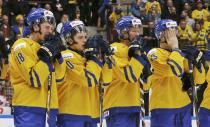 Sweden's (L-R) Andre Burakowsky, Lukas Bengtsson, Gustav Olofsson, and Nick Sorenson react to losing to Finland in overtime of their IIHF World Junior Championship gold medal ice hockey game in Malmo, Sweden, January 5, 2014. REUTERS/Alexander Demianchuk (SWEDEN - Tags: SPORT ICE HOCKEY)