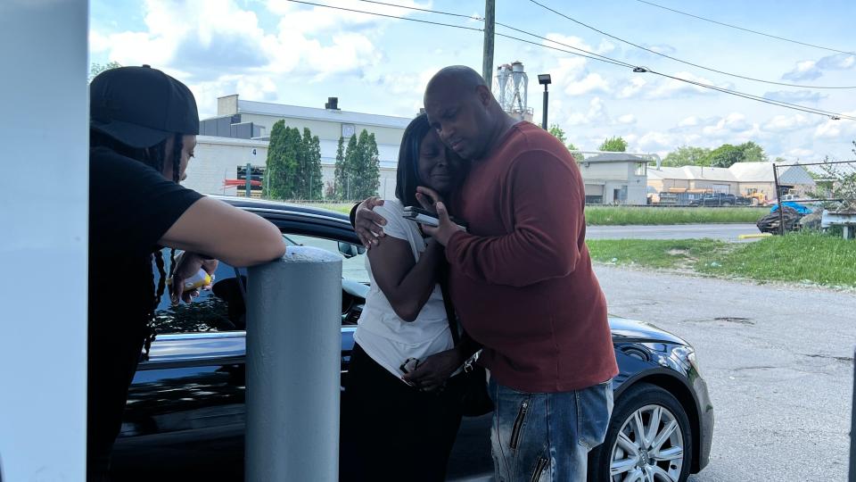 DaJuan Thrasher comforts his wife LaShun Thrasher on Tuesday, May 21, 2024. The couple's son, JaDen Thrasher, was killed the night before in a shooting in the 4000 block of East 12th Street.