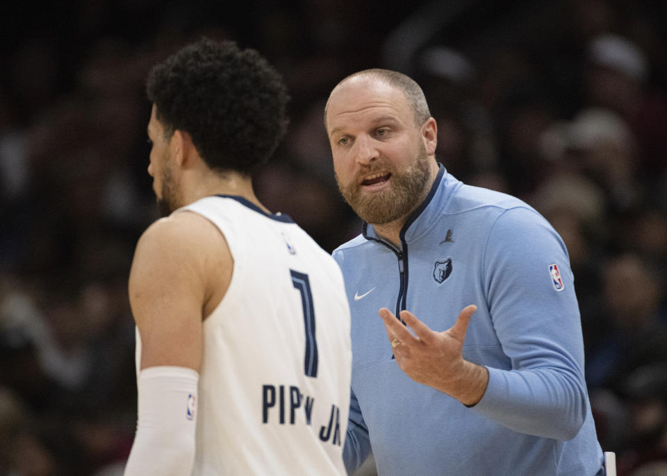 Memphis Grizzlies head coach Taylor Jenkins speaks with Scotty Pipen Jr. (1) during the first half of an NBA basketball game against the Cleveland Cavaliers in Cleveland, Wednesday, April 10, 2024. (AP Photo/Phil Long)