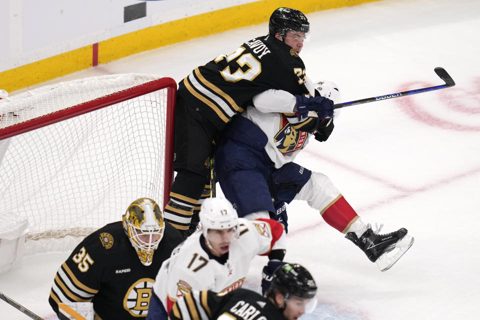 Boston Bruins defenseman Charlie McAvoy wraps up Florida Panthers center Aleksander Barkov (16) during the first period of an NHL hockey game, Monday, Oct. 30, 2023, in Boston. (AP Photo/Charles Krupa)