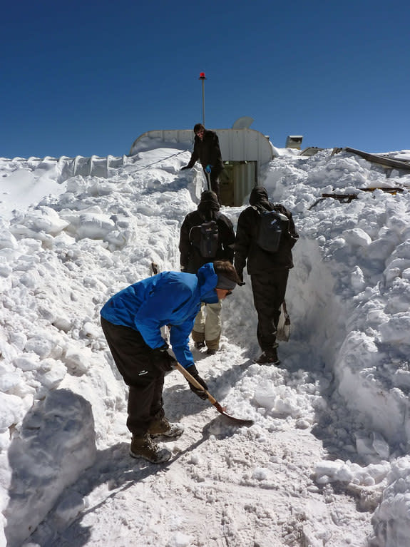 The ArTeMiS space camera team shovel snow to get into the APEX control building on the Chajnantor Plateau in northern Chile. In the foreground is Laurent Clerc, in the middle are Jérôme Martignac (left) and François Visticot (right), and in the