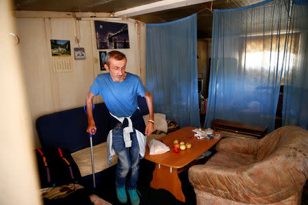 Bosnian Croat Alojz Stjepic, an internally displaced person from Kiseljak, walks inside his house at a reception center Tasovcici where IDPs live, near Capljina, Bosnia and Herzegovina, September 27, 2018. REUTERS/Dado Ruvic