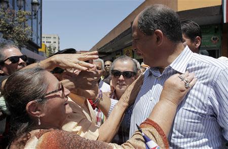 Luis Guillermo Solis, presidential candidate of the Citizens' Action Party (PAC), speaks to his supporters during a walk in San Jose April 4, 2014. Costa Rica's center-left presidential candidate Solis is expected to cruise to victory in the run-off election on April 6 after his ruling party rival quit campaigning in a bizarre twist last month. REUTERS/Juan Carlos Ulate