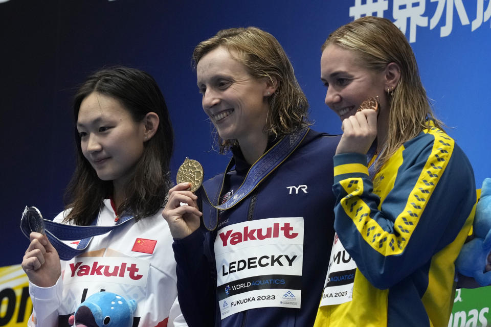 Medalists, from left to right, Li Bingjie of China, silver, Katie Ledecky of the U.S., gold, and Ariarne Titmus of Australia, bronze, celebrate during the medal ceremony for the women's 800m freestyle at the World Swimming Championships in Fukuoka, Japan, Saturday, July 29, 2023. (AP Photo/Eugene Hoshiko)